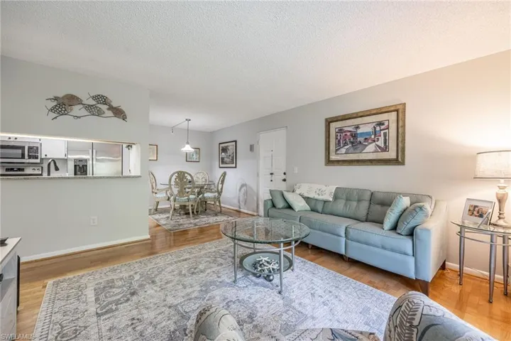 Living room with hardwood / wood-style floors and a textured ceiling