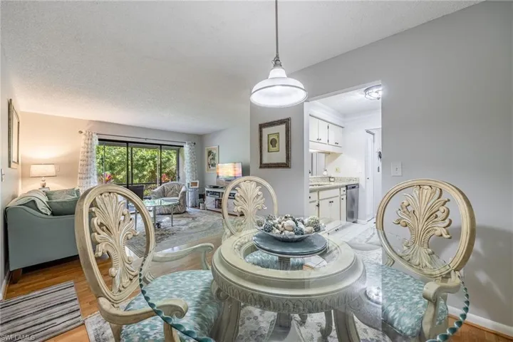 Dining room with light hardwood / wood-style flooring and a textured ceiling