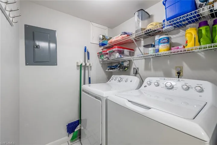Laundry room with washing machine and dryer and electric panel