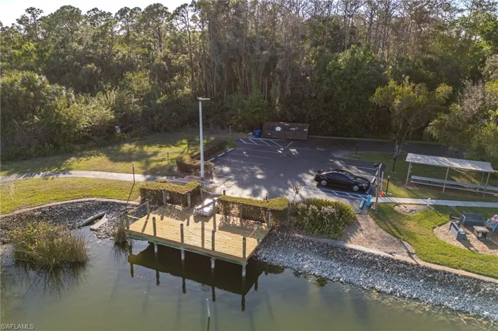 View of dock featuring a yard and a water view