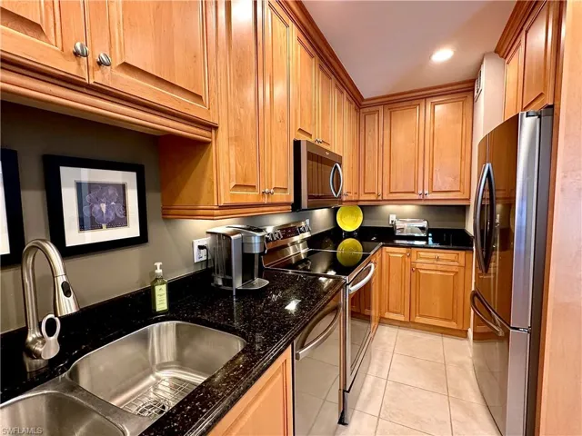 The upgraded kitchen boasts beautiful Custom 42” maple cabinets, granite countertops, and recessed  under-counter lighting