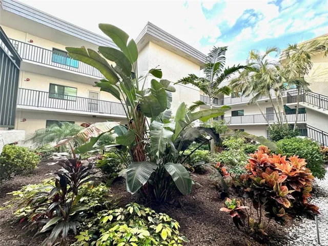 Garden-like courtyard setting for those who love lushly colored plants and bushes inter-mixed with palm trees. The blue skies come with the territory