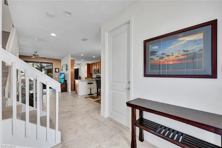 Hall with recessed lighting and light tile patterned floors