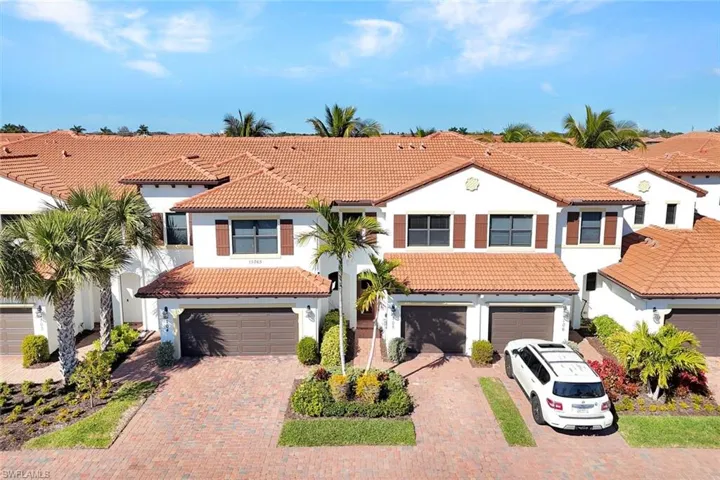 Mediterranean / spanish-style home with a tile roof, a garage, stucco siding, and decorative driveway