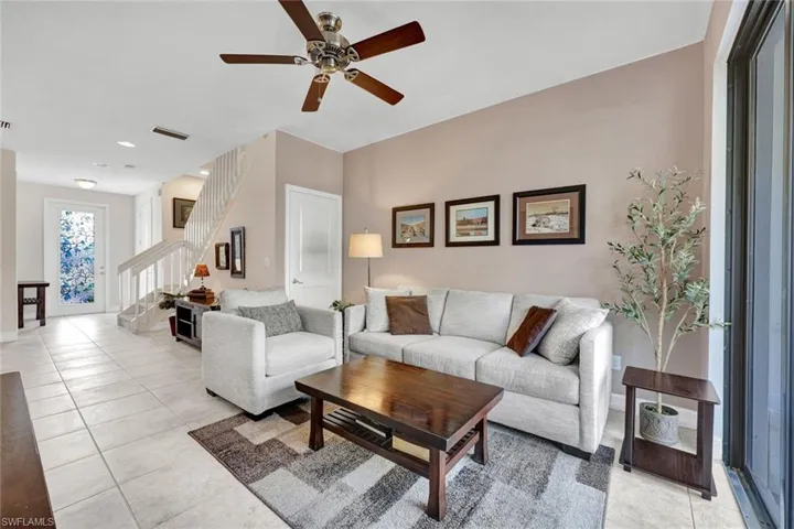 Living area featuring ceiling fan, light tile patterned floors, and recessed lighting