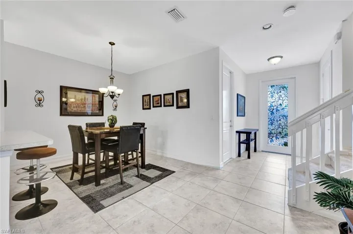 Dining area featuring light tile patterned floors and a chandelier