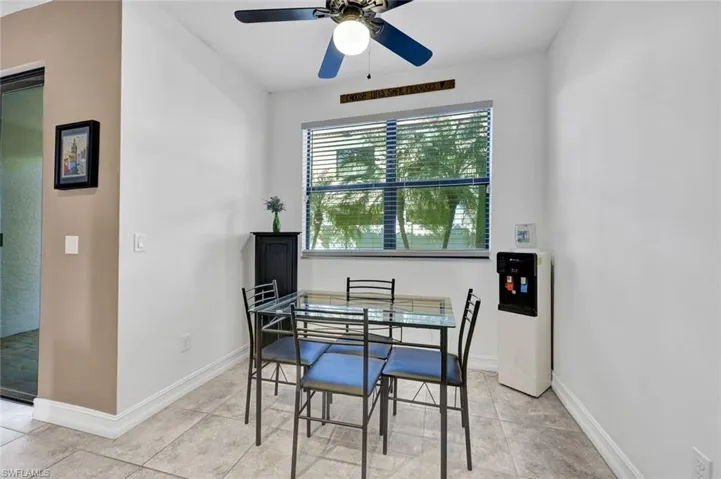 Dining room featuring a ceiling fan and baseboards