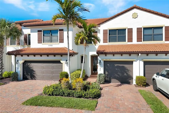 Mediterranean / spanish home featuring an attached garage, stucco siding, a tile roof, and decorative driveway