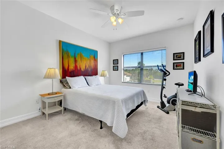 Bedroom with light carpet and ceiling fan
