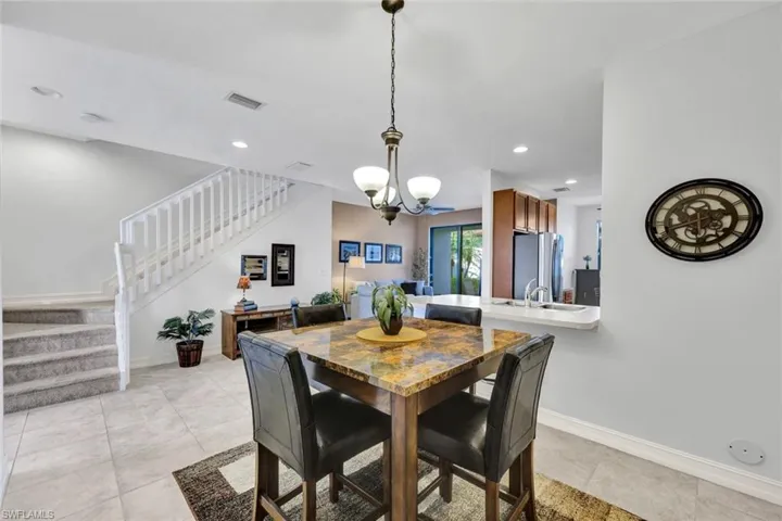 Dining room featuring light tile patterned floors and hanging lights