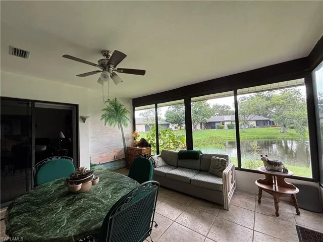 Screened enclosure with ceramic tile flooring and a ceiling fan