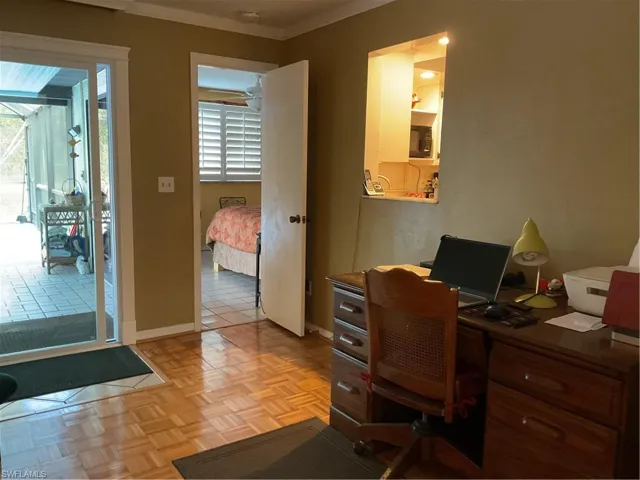 Office space featuring crown molding and baseboards