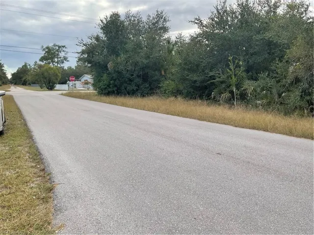 View of asphalt road featuring traffic signs
