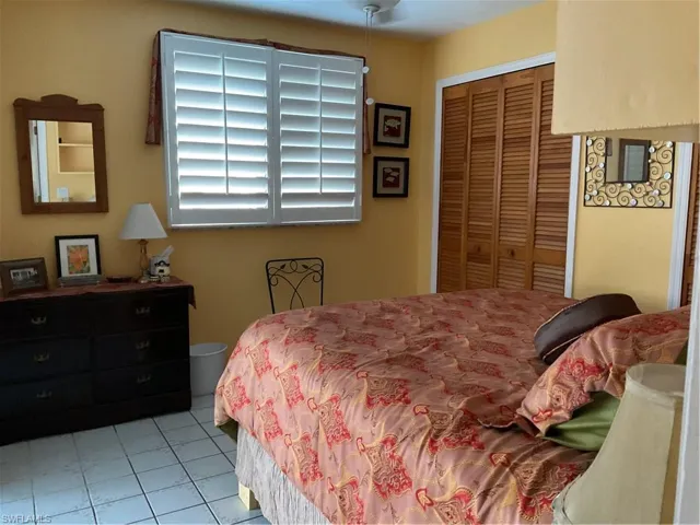 Bedroom featuring a closet and light tile patterned flooring