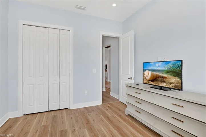 Unfurnished bedroom featuring light wood-style flooring and a closet