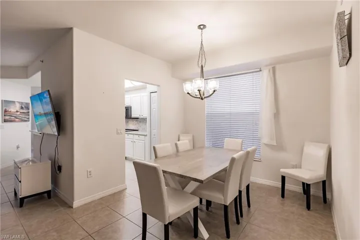 Tiled dining space with an inviting chandelier