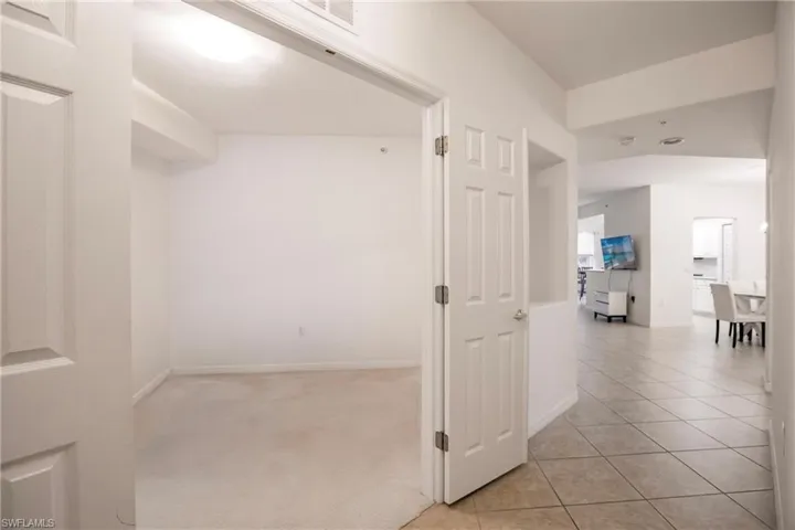 Corridor with light colored carpet