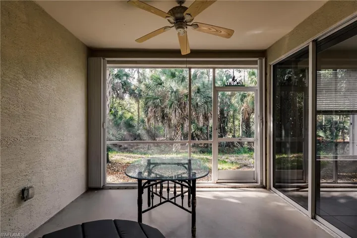 Unfurnished sunroom featuring ceiling fan and a healthy amount of sunlight