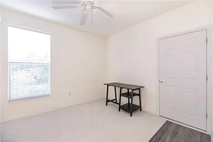Unfurnished room featuring light carpet and ceiling fan