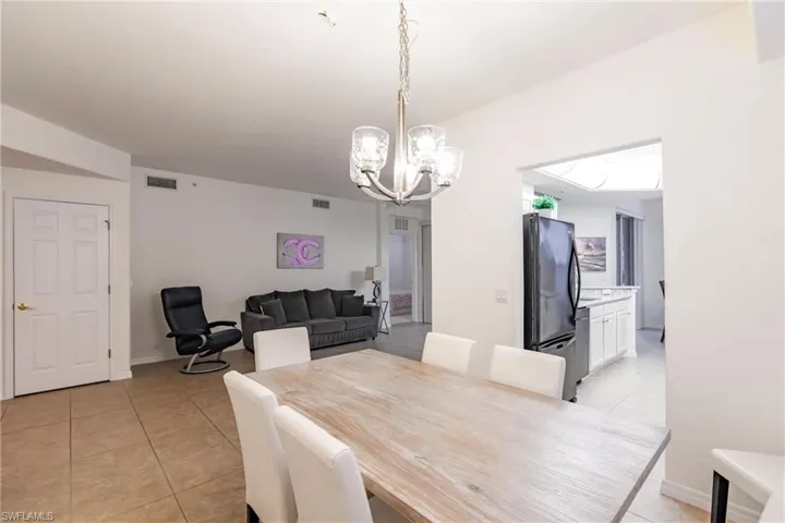 Tiled dining room with an inviting chandelier