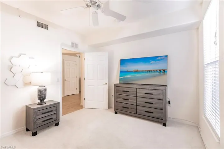 Bedroom with light carpet and ceiling fan