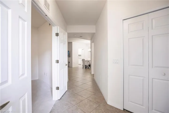 Hall with light tile patterned flooring