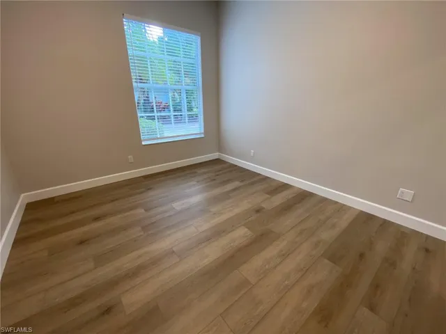 Spare room with wood finished floors and baseboards