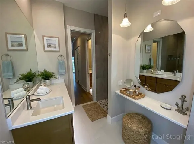 Full bath with vanity and baseboards