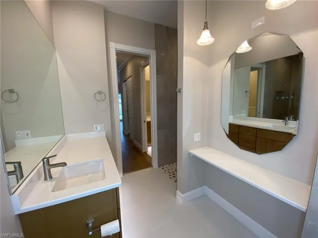 Full bath featuring vanity and baseboards