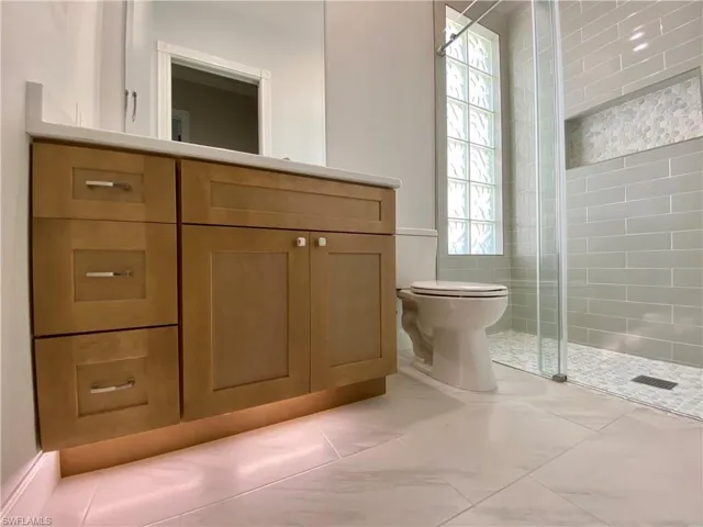 Bathroom featuring vanity and a stall shower