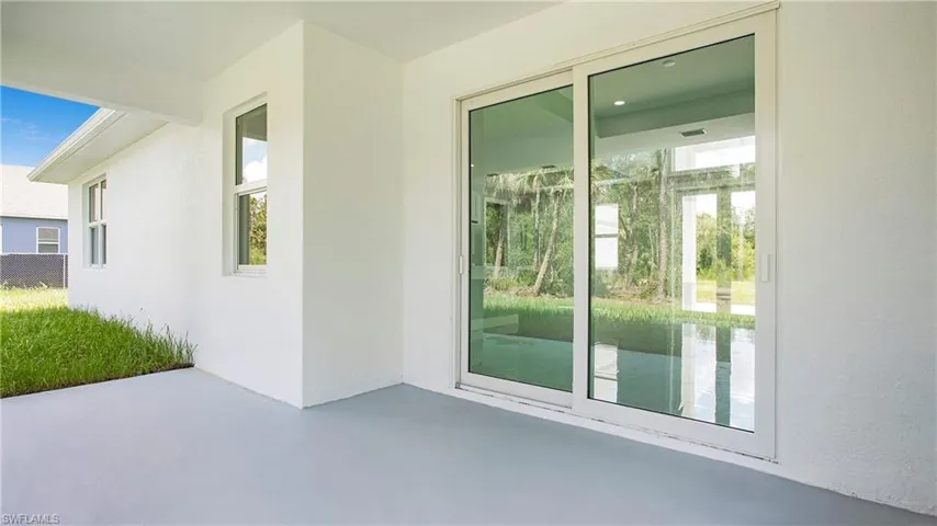 Entrance to property featuring a patio and stucco siding