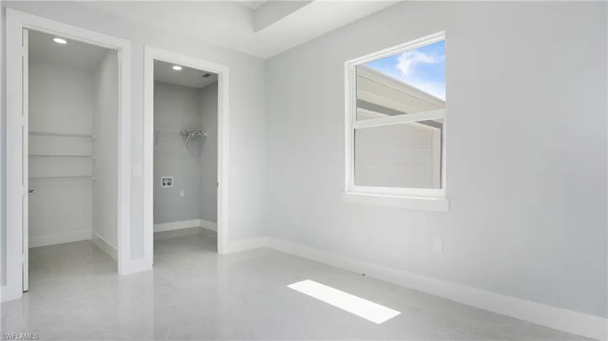 Unfurnished bedroom with a spacious closet and recessed lighting