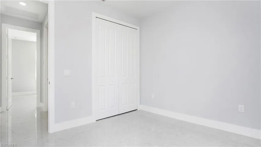 Unfurnished bedroom featuring a closet and baseboards