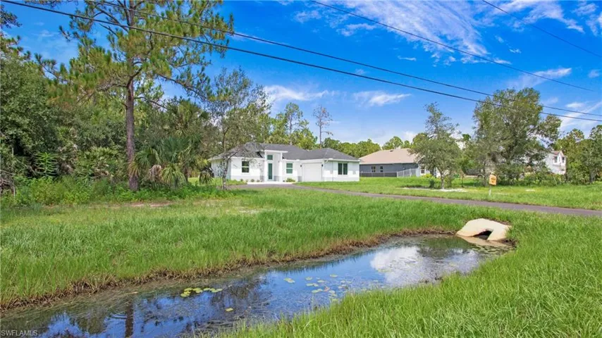 Rear view of property featuring a water view and an attached garage