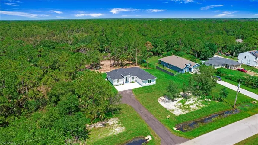Aerial view of property's location featuring a heavily wooded area