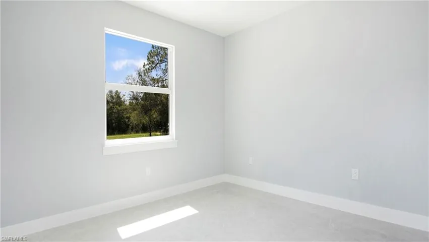 Unfurnished room featuring baseboards