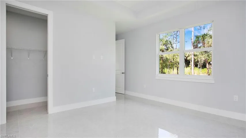 Unfurnished bedroom featuring baseboards and a closet