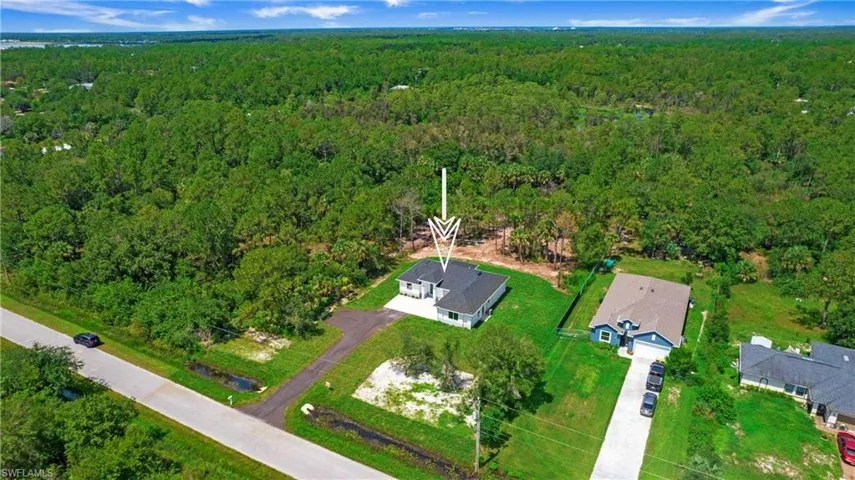 Aerial overview of property's location featuring a forest