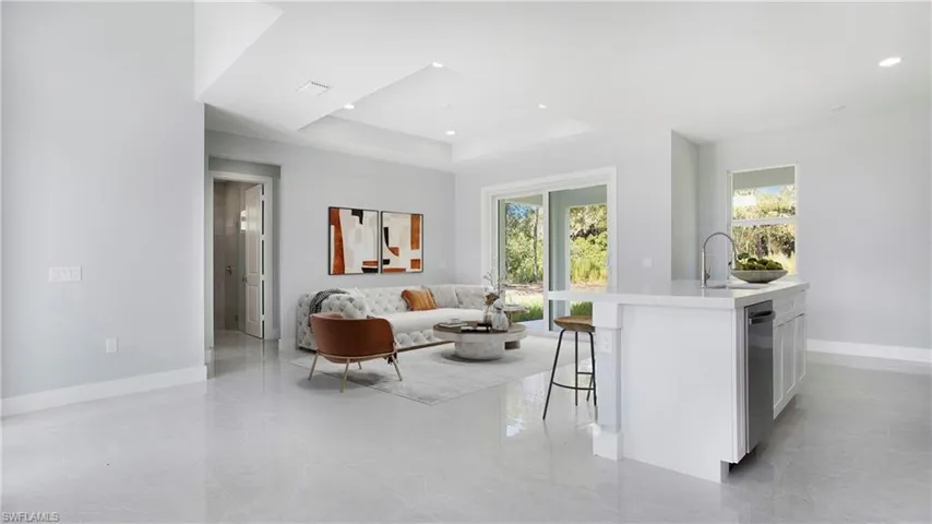 Living room with a tray ceiling and recessed lighting