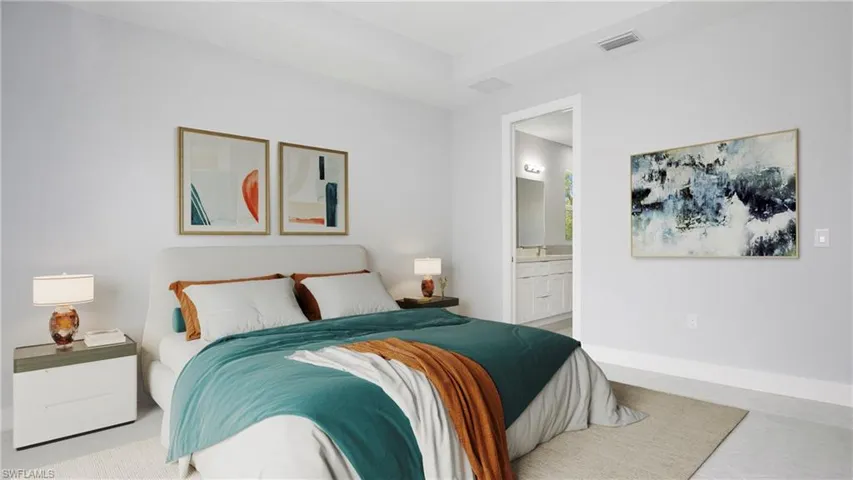 Bedroom featuring ensuite bathroom and baseboards