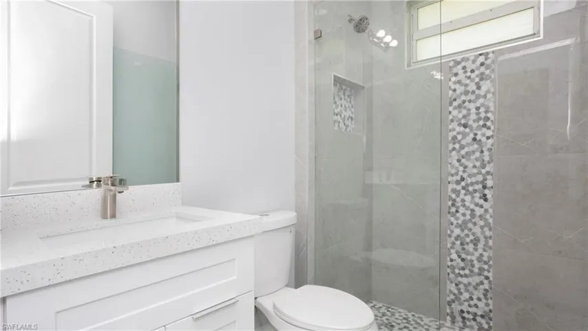 Full bath featuring vanity and a shower stall
