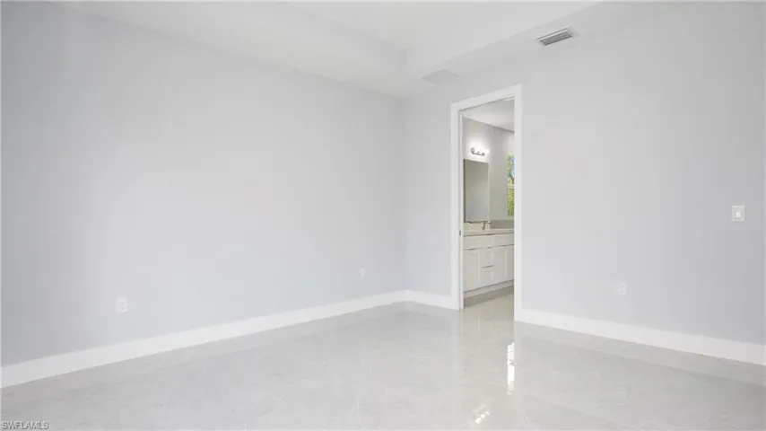 Unfurnished room with baseboards