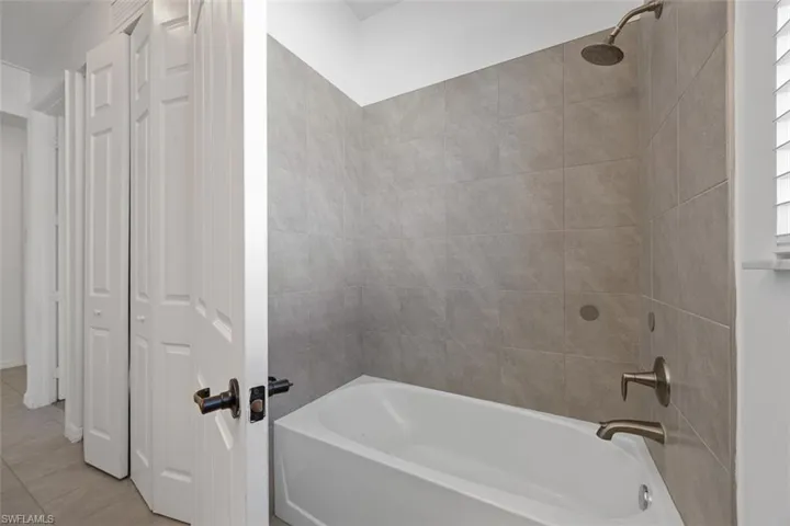 Full bathroom with bathing tub / shower combination and tile patterned floors