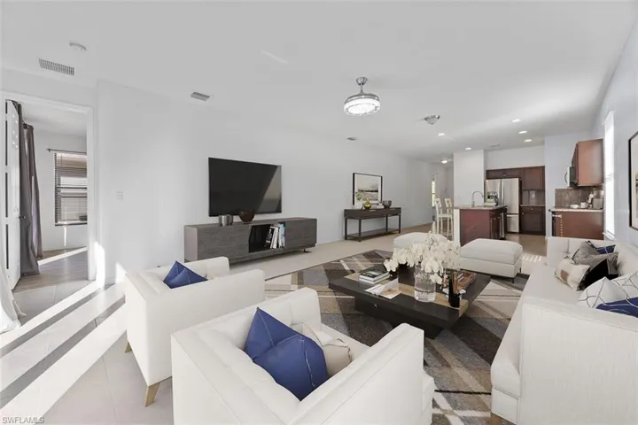 Virtually Staged-Living room with light tile patterned floors, recessed lighting, and visible vents