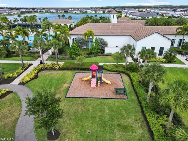 View of property's community with a yard, playground community, and a residential view
