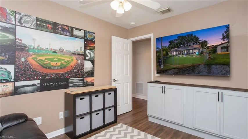Living room featuring dark hardwood / wood-style floors and ceiling fan