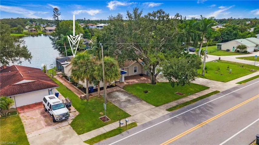 Birds eye view of property with a water view