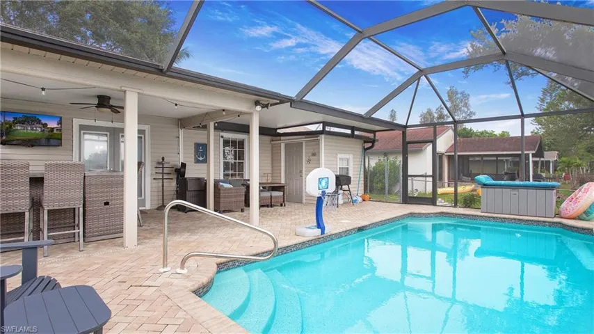 View of pool with a patio, a lanai, and ceiling fan