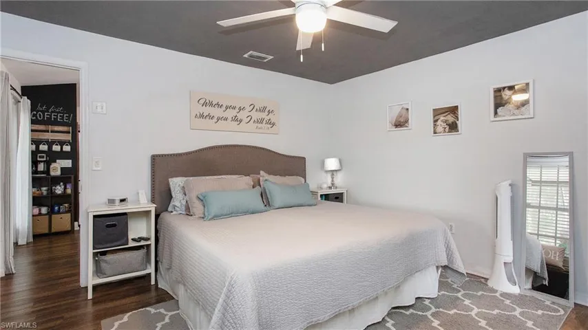 Bedroom featuring dark hardwood / wood-style flooring and ceiling fan