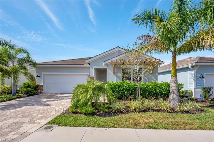 Ranch-style house with stucco siding, decorative driveway, and an attached garage